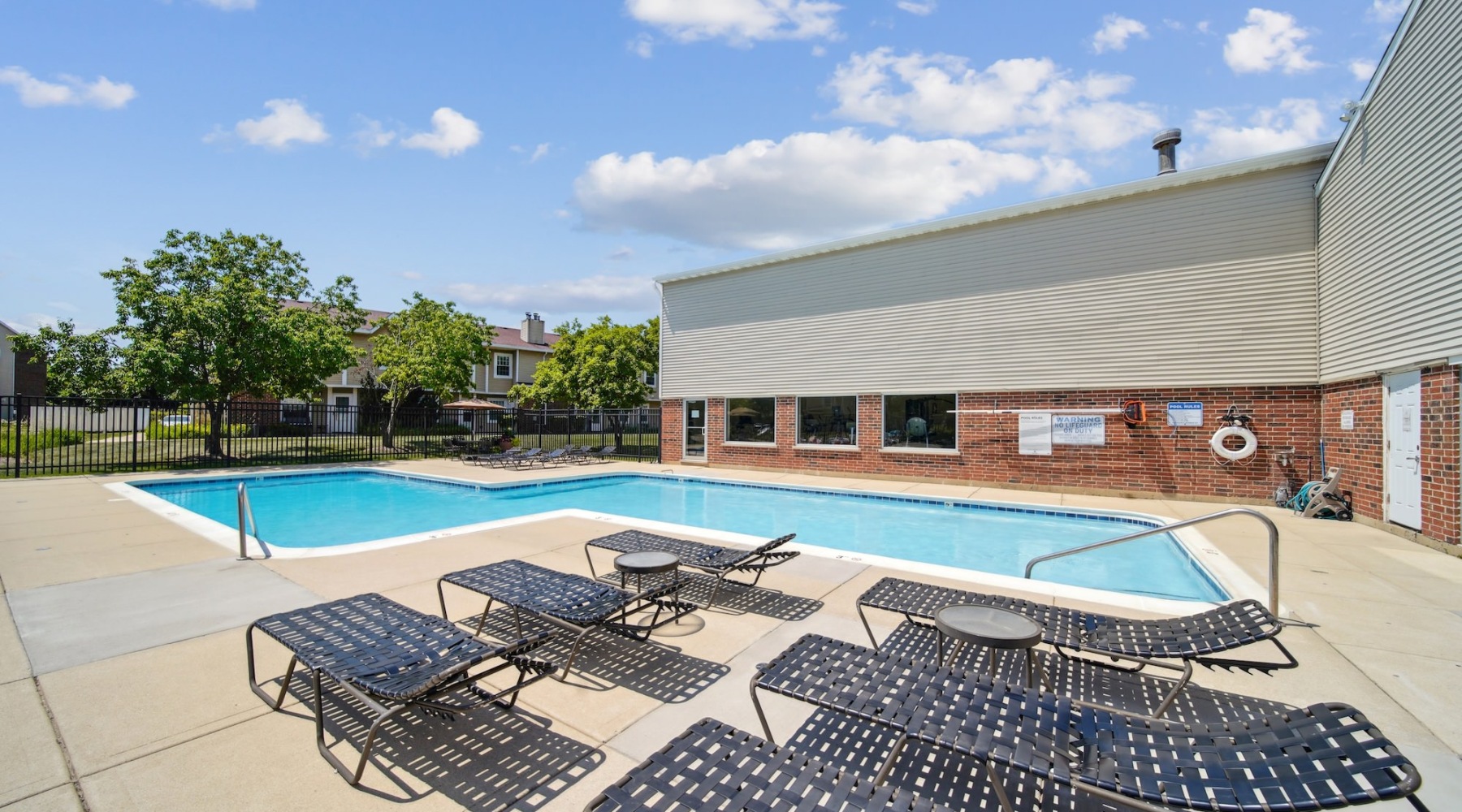 Resort-style swimming pool with lounge seating
