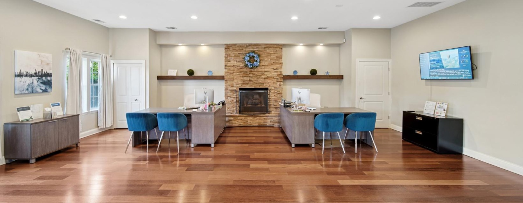 a large room with a wood floor and a fireplace